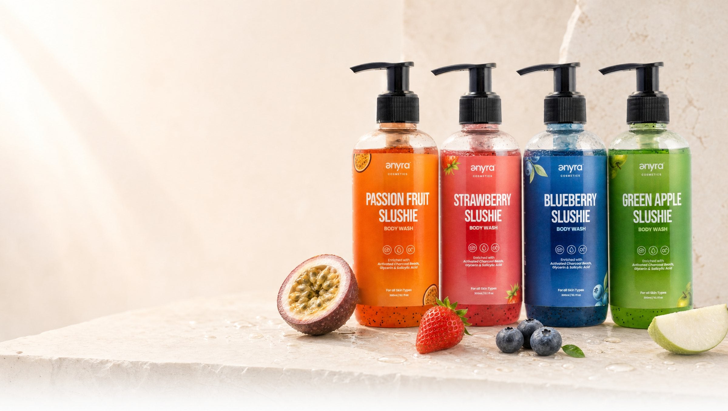 Passion Fruit, Strawberry, Blueberry and Green Apple Slushie body washes on wet terracotta stone with their fruit